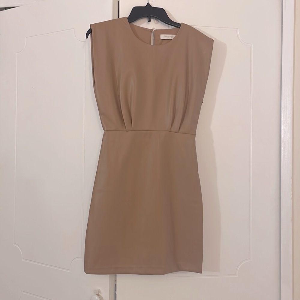 Vegan leather minidress with front tuck details and side zip for easy styling.